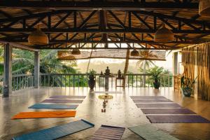 a room with a bunch of yoga mats on the floor at Isolabella Ayurveda Hotel Hiriketiya in Nilwella
