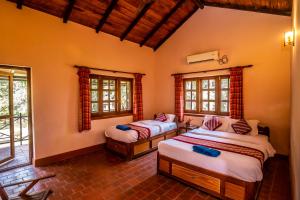 a bedroom with two beds in a room at Royal Park Hotel in Sauraha