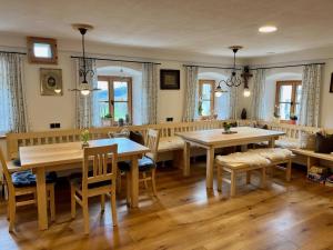 a dining room with two tables and chairs at Waldlerhof in Patersdorf