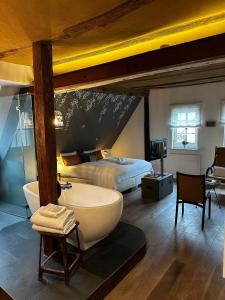 a bathroom with a bed and a tub in a room at die Träumerei GmbH in Michelstadt +27 photos