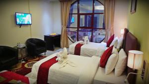 Voodi või voodid majutusasutuse Mirage Hotel Al Aqah toas