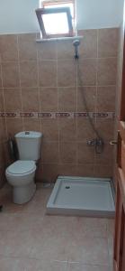 a bathroom with a toilet and a bath tub at Selin Pansiyon in Kemer