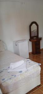 a bedroom with a bed with towels on it at Selin Pansiyon in Kemer +5 photos