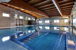a large swimming pool in a building at PenichePraia - Bungalows, Campers & SPA in Peniche