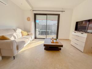 a living room with a couch and a coffee table at Centrale climatisée deux chambres terrasse parking, saint raphael in Saint-Raphaël