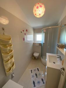 a bathroom with a sink and a toilet and a mirror at Mobile Homes Camping Biograd in Biograd na Moru +108 photos
