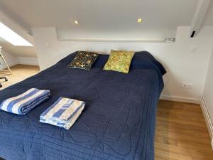 a blue bed with pillows on it in a room at L'Ancrage in Saint Malo +21 photos