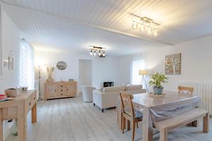 a living room with a couch and a table at Gite du cerisier in Lanouaille