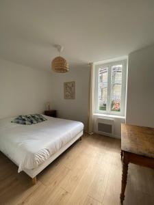 Ένα ή περισσότερα κρεβάτια σε δωμάτιο στο Le dortoir de Marie