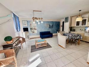 a kitchen and a living room with a table at Casa dello Rio - Elba Affitti in Rio nellʼElba +2 photos
