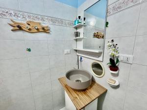 a small bathroom with a sink and a mirror at Casa dello Rio - Elba Affitti in Rio nellʼElba