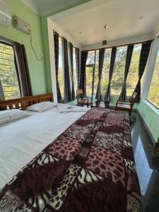 a bedroom with a bed with a giraffe blanket on it at Yelagiri GoldHill Resort in Yelagiri +50 photos
