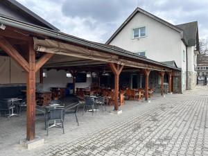a patio with tables and chairs in front of a building at Penzión Tandem in Martin