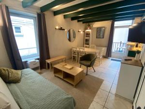 a living room with a couch and a table at Residence Montlosier in Le Mont-Dore