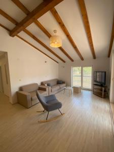 a living room with a chair and a couch at Mobile Homes Camping Biograd in Biograd na Moru