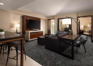 a living room with a couch and a television at Hyatt Regency Sacramento in Sacramento