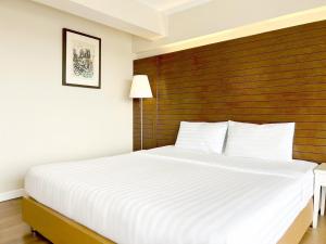 Postel nebo postele na pokoji v ubytování Ayothaya Riverside Hotel