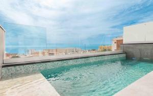 a swimming pool on the roof of a building at Seaview house with rooftop pool, game room, parking REMS in Torremolinos