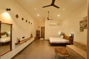 Mountain Woods Farmstay, Khopoli Pure Veg في خوبولي: غرفة نوم بها سريرين ومروحة سقف +17 صورة