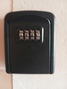 a black electrical switch on a wall at Apartament Okrzei in Włocławek