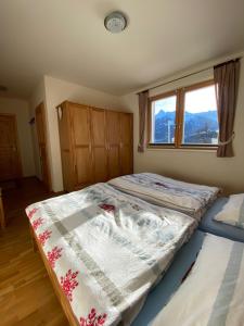 dwa łóżka pojedyncze w sypialni z oknem w obiekcie Haus Zimba Ferienwohnung am Bartholomäberg w mieście Bartholomäberg