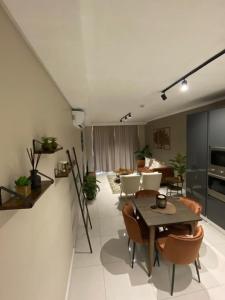 a living room with a table and chairs at Stunning 2 bedroom condo at Ellipse Midrand in Midrand