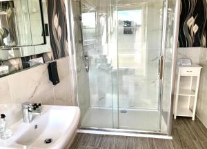 a bathroom with a shower and a sink at The Clubhouse Nairn in Nairn +47 photos