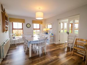 a kitchen and dining room with a table and chairs at Clondallon Cottage in Rathmullan