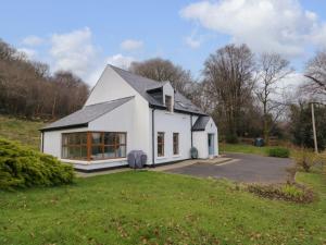 a white house with a black roof at Clondallon Cottage in Rathmullan