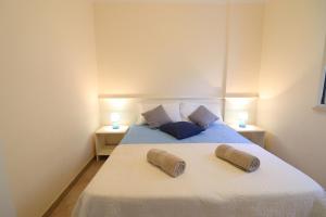 a bedroom with a bed with two pillows on it at Casa Asia Otranto Beach & Center AC, WiFi & 4 Sleeps in Otranto