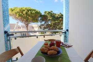 a table with a plate of food on a balcony at Casa Asia Otranto Beach & Center AC, WiFi & 4 Sleeps in Otranto