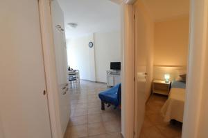 a hallway with a room with a bed and a desk at Casa Asia Otranto Beach & Center AC, WiFi & 4 Sleeps in Otranto