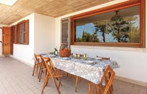 a dining room table with chairs and a window at Panoramic villa with pool and gym in Grottammare