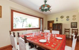 a dining room with a table with chairs and a chandelier at Panoramic villa with pool and gym in Grottammare