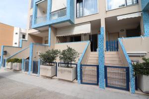 a building with blue gates in front of it at Casa Asia Otranto Beach & Center AC, WiFi & 4 Sleeps in Otranto