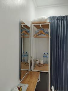 a room with a desk and some water bottles at Himandhoo sweet dreams in Himandhoo 