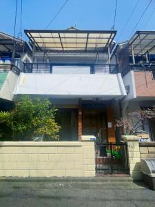 a house with a white awning on top of it at 福苑李 in Osaka
