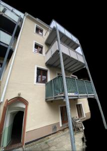 a tall building with a ladder in front of it at FW 50 - Mitten in der historischen Altstadt mit Balkon in Görlitz