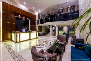 a lobby of a hotel with a woman in the background at PRIMOTEL Grand Al Taoubah in Jeddah +38 photos
