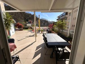 a patio with a table and chairs on a balcony at Sol Garden - Hostel with a Soul in Pula