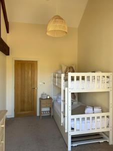A bed or beds in a room at Peipards Barn