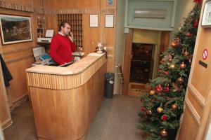 a man talking on a cell phone in a kitchen with a christmas tree at Ilios in Thessaloniki