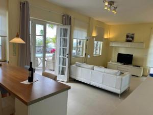 a living room with a white couch and a table at Appartement Fenia in Las Manchas