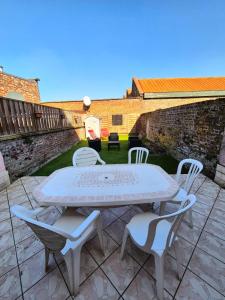 a white table and chairs on a patio at Le Repère - Maison 5 Chambres proche Vieux Lille in Tourcoing
