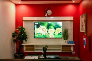 a flat screen tv sitting on top of a wall at Same Stay Inn in Francistown +6 photos