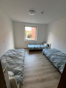 a room with two beds and a window at Monteurswohnung Rheine 1 in Rheine +8 photos