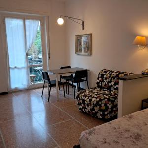a living room with a couch and a table and chairs at Sportrek in Levanto