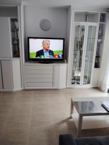a living room with a flat screen tv in a wall at Casa Roc de Sant Gaietà in Comarruga
