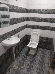 a bathroom with a toilet and a sink at Kashi Kutir in Varanasi