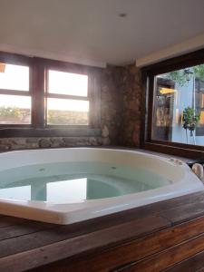 a large bath tub in a room with two windows at 29 on Edward - 4 bedroom House in Cape Town